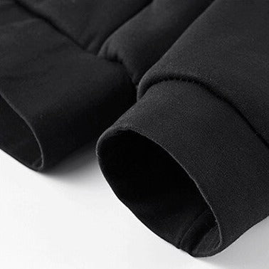 Close-up of black sherpa-lined men's sweatpants cuffs, showcasing warm and soft fabric for winter comfort.
