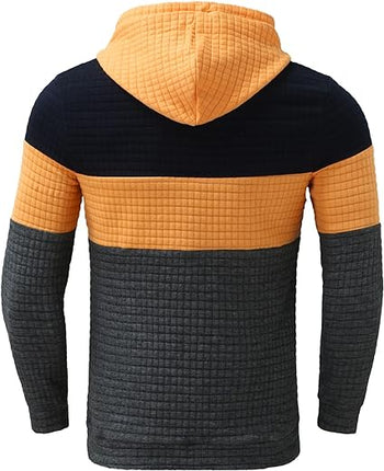 Buzo Melbourne con capucha ajustable, diseño en bloques naranja, gris y negro, cómodo y casual para hombre, ideal para días frescos.