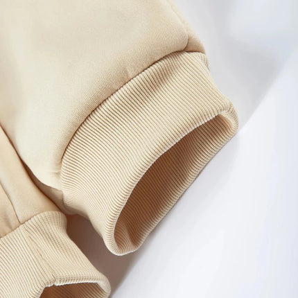 Close-up of beige ribbed cuff on jogger pants showcasing thick fabric and cozy design.