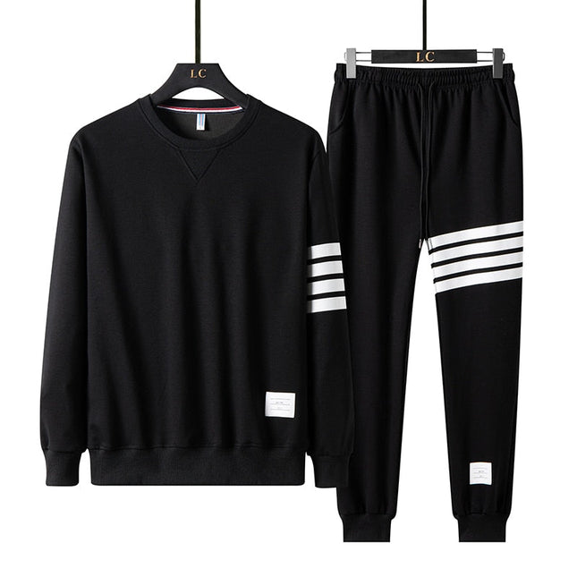 Conjunto de buzo y pantalón Drupin para hombre en negro con detalles blancos, ideal para estilo casual y confort diario.