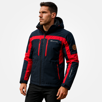 Man wearing Campera Térmica Snow Ice jacket, designed for extreme cold conditions up to -30°C, in blue and red with hood.