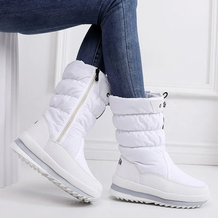 White women's waterproof synthetic leather snow boots with side zipper, perfect for winter, shown on model wearing blue jeans.