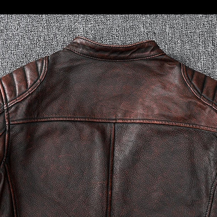 Elegant 100% cowhide leather jacket showcasing back detail on a textured surface, emphasizing premium quality and craftsmanship.