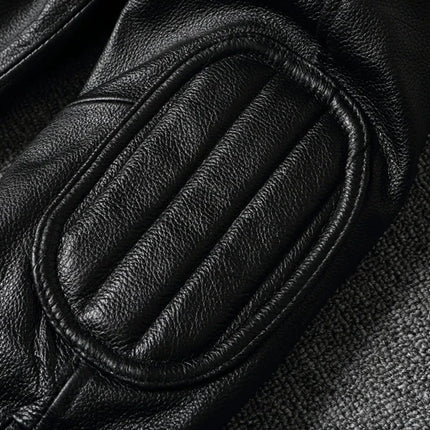 Close-up of black 100% cowhide leather jacket sleeve with detailed stitching and padding, showcasing texture and quality.