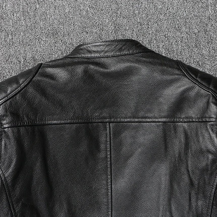Campera de cuero negro 100% vacuno sobre fondo gris, vista trasera destacando la textura del cuero y el diseño de la chaqueta.