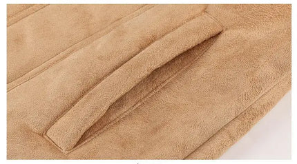 Close-up of camel-colored suede jacket with detailed view of pocket.