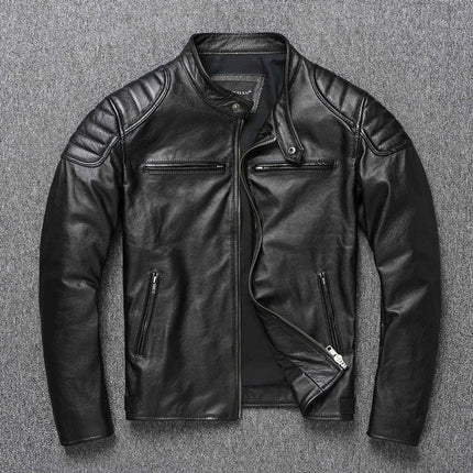 Black 100% cow leather jacket with zippered pockets and quilted shoulders, displayed on a gray background.