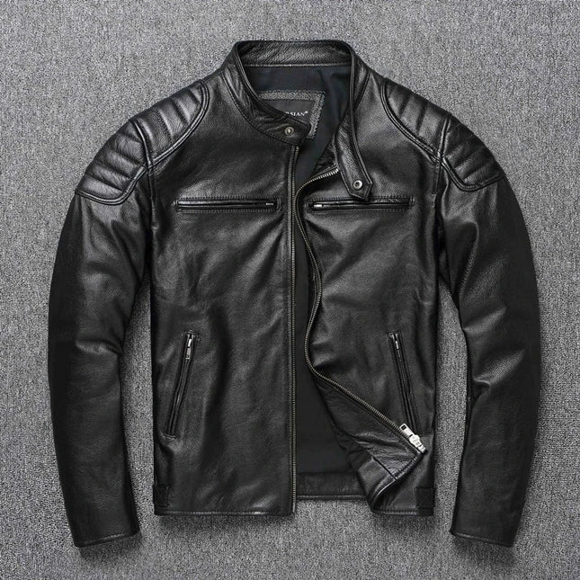 Black 100% cow leather jacket with zippered pockets and quilted shoulders, displayed on a gray background.