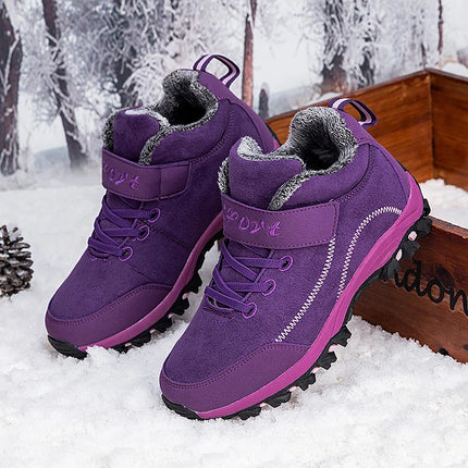 Purple women's winter boots with faux fur lining, perfect for snowy weather, featuring durable soles for excellent traction.