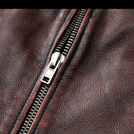 Close-up of a genuine cowhide leather jacket zipper with rich texture and deep brown color, showcasing craftsmanship and quality.
