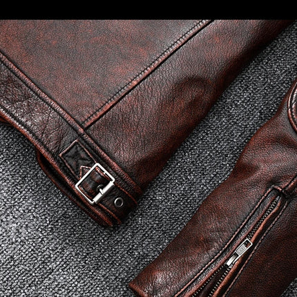 Close-up of a brown 100% genuine cowhide leather jacket with zippers and buckle detail on textured surface.