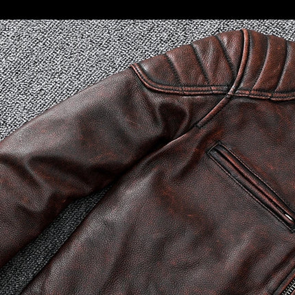 Close-up of a 100% cowhide leather jacket with padded details and zippered pocket.