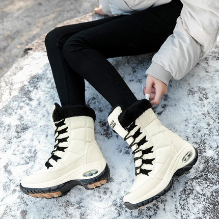 Woman wearing high-quality winter boots sitting on snow-covered ground, showcasing stylish and durable design for cold weather.