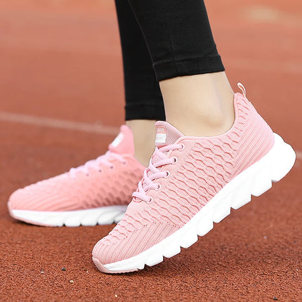 Pink lightweight and breathable women's athletic shoes on track surface.