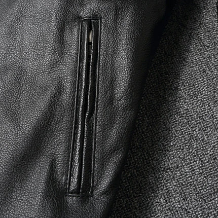Close-up of a 100% cowhide leather jacket showcasing texture, pockets, and design details.