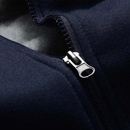 Close-up of navy Arctic Flex hoodie zipper with fleece lining detail showcasing premium embroidery and warmth.