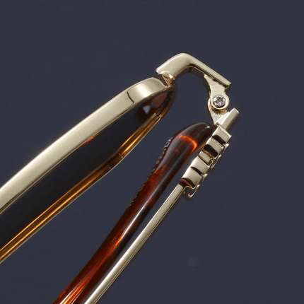 Detalle bisagra gafas de sol hombre Aureon Hexa-Core, marco dorado con engranaje. Estilo futurista, protección UV400.