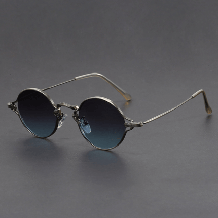 Gafas de sol redondas para hombre con armazón de metal, estilo Cobain. Diseño clásico y audaz, ideal para un look alternativo.