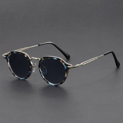 Gafas de sol retro Helios para hombre con lentes redondos y patillas metálicas, estilo vintage y protección UV400, moda solar audaz.