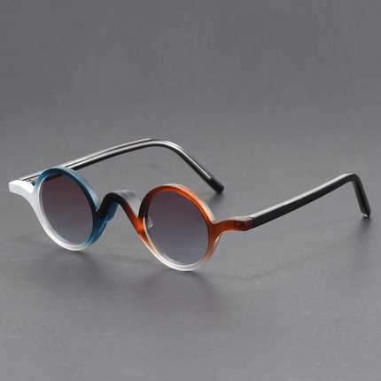 Gafas de sol retro Warhol para hombre, con armazón de acetato esculpido, puente ondulado y lentes redondos con tinte, estilo pop art.