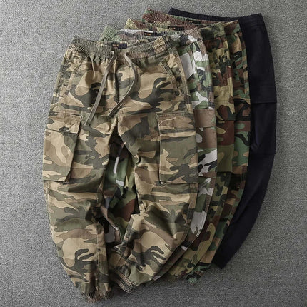 Men's camouflage military pants in various colors displayed on a gray background.