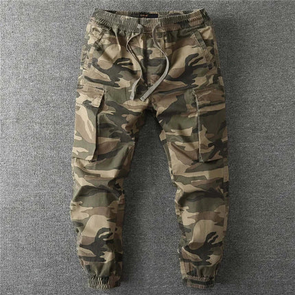 Men's camo military pants with elastic waist and cargo pockets on a neutral background.