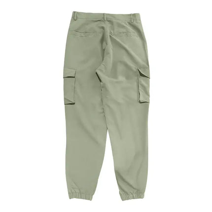 Green versatile sports pants with pockets and elastic cuffs, suitable for various activities and available in multiple sizes.