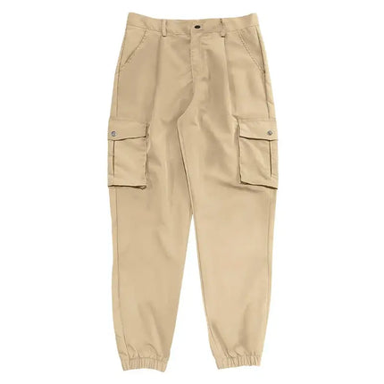 Beige versatile sports pants with pockets, casual design, suitable for various activities.