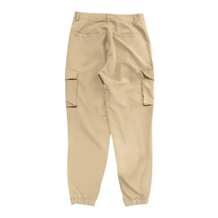 Beige versatile sports pants with elastic cuffs and cargo pockets.