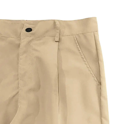 Close-up view of versatile beige sports pants with button and pocket detail, perfect for comfort and style.
