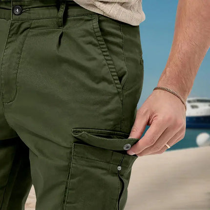Close-up of versatile cargo pants with side pocket detail on beach background.