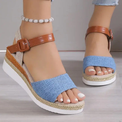 Stylish women's wedge sandals with blue fabric straps and brown ankle buckle, ideal for comfortable summer events.