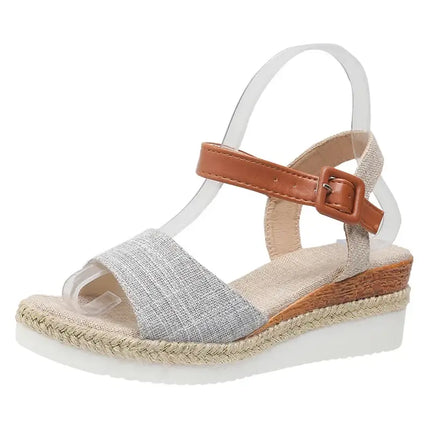 Elegant women's wedge sandal with brown strap and modern design, perfect for summer events. Comfortable and stylish for any occasion.