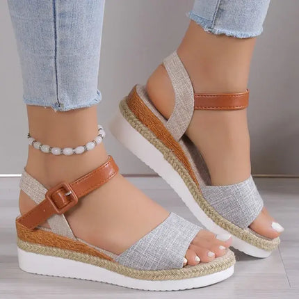 Elegant women's wedge sandals with brown strap and modern design, perfect for summer days and events.