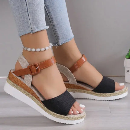 Sandalia estilo fino mujer en negro y marrón, con diseño de cuña suave, ideal para elegancia y comodidad en verano.