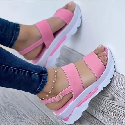 Woman wearing pink Sandalia Hebilla Zen sandals with lightweight wedge and adjustable buckle, showcasing style and comfort.