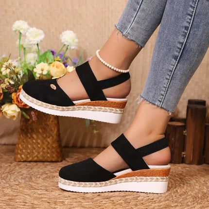 Sandalia Urban Cuña de estilo gladiador moderno, color negro, con plataforma tipo cuña y hebilla ajustable, ideal para el verano.