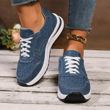 Denim-style women's sneakers in indigo blue, featuring a casual design perfect for everyday wear, paired effortlessly with jeans.