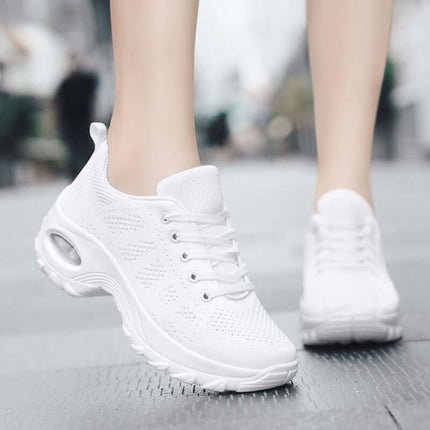 White Zapatillas Urban Trek Zenithi sneakers with Deep Care technology for comfort and fitness, showcased on a street pavement.