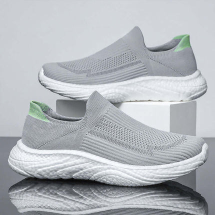 Gray breathable women's casual sneakers with green accents, lightweight design, perfect for versatile use and comfortable wear.