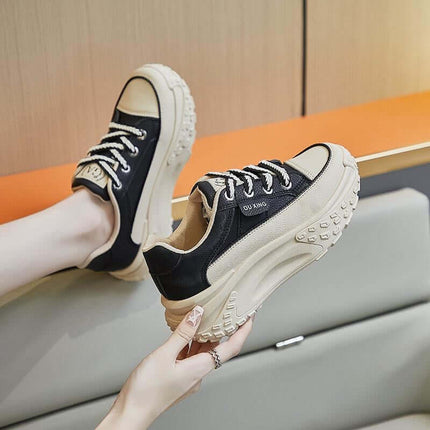 Fashionable thick-soled elevator sneakers in black and beige for modern style and comfort.