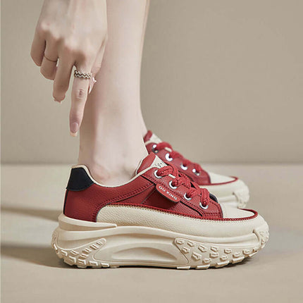 Modern red sneakers with thick sole and elegant upper design, highlighting comfort and style for casual wear.