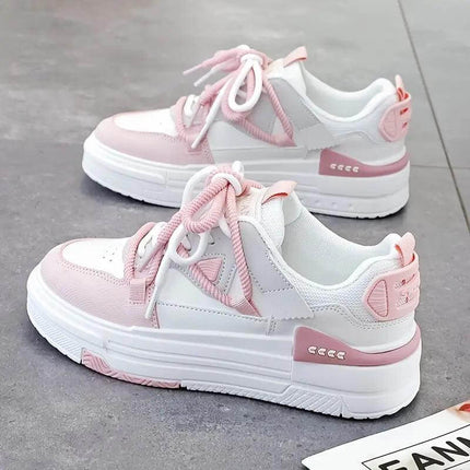 Fashionable pink and white sneakers with ergonomic design for optimal comfort and impact support, ideal for daily activities.
