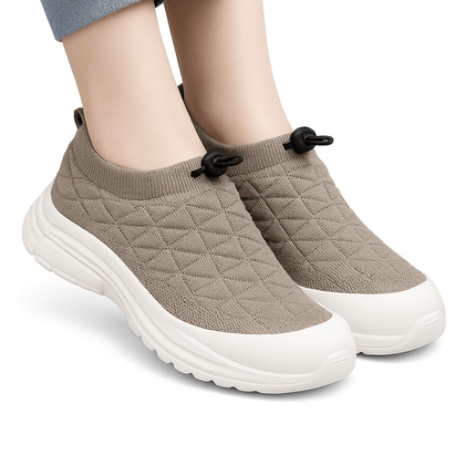 SoftWalk Urban sneakers in beige with breathable insole and flexible material, designed for comfort and style, worn on feet with jeans.