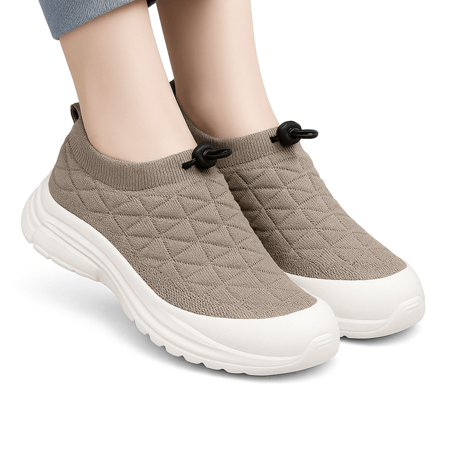 SoftWalk Urban sneakers in beige with breathable insole and flexible material, designed for comfort and style, worn on feet with jeans.