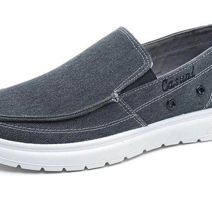 Zapatos casuales de lona para hombre en gris con suela blanca, ideales para caminar. Disponibles en varios talles Argentina y Europa. Elegantes y cómodos.