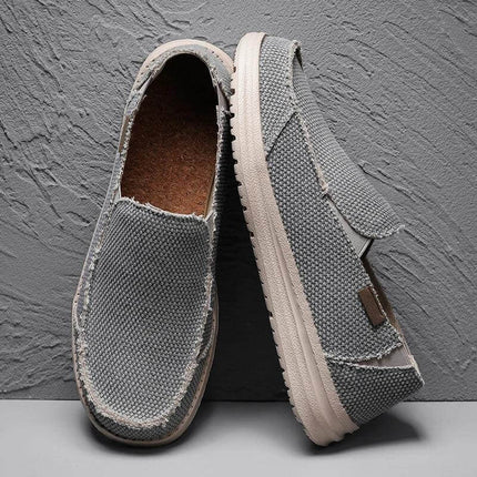 Zapatos informales de lona grises transpirables para hombre, estilo casual y cómodo, ideal para un look relajado.