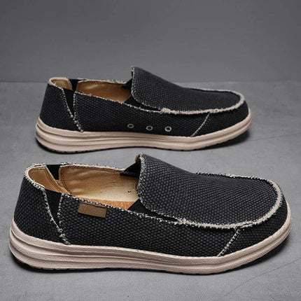 Zapatos casuales hombre transpirables de lona negra con diseño moderno y cómodo.